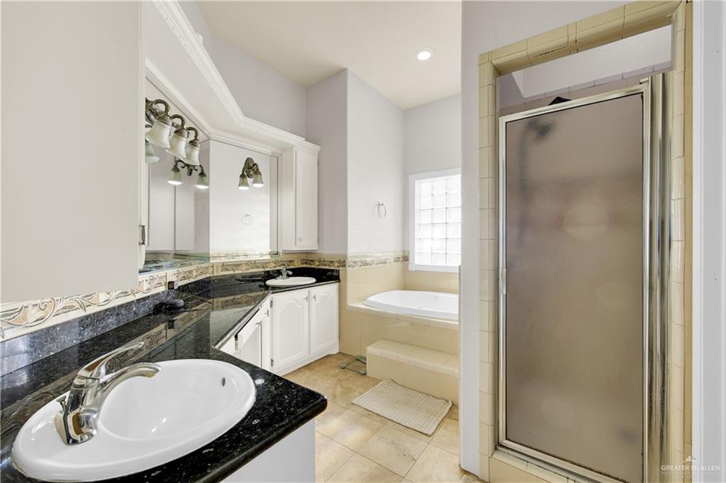 3517 Princess Street Edinburg, TX 78539 - Photo 16 of 22 a bathroom with a sink double vanity mirror and a bathtub