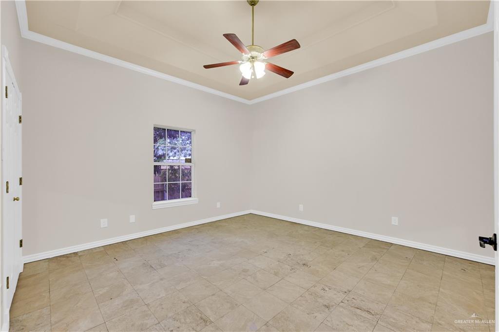 3517 Princess Street Edinburg, TX 78539 - Photo 17 of 22 an empty room with window and a ceiling fan