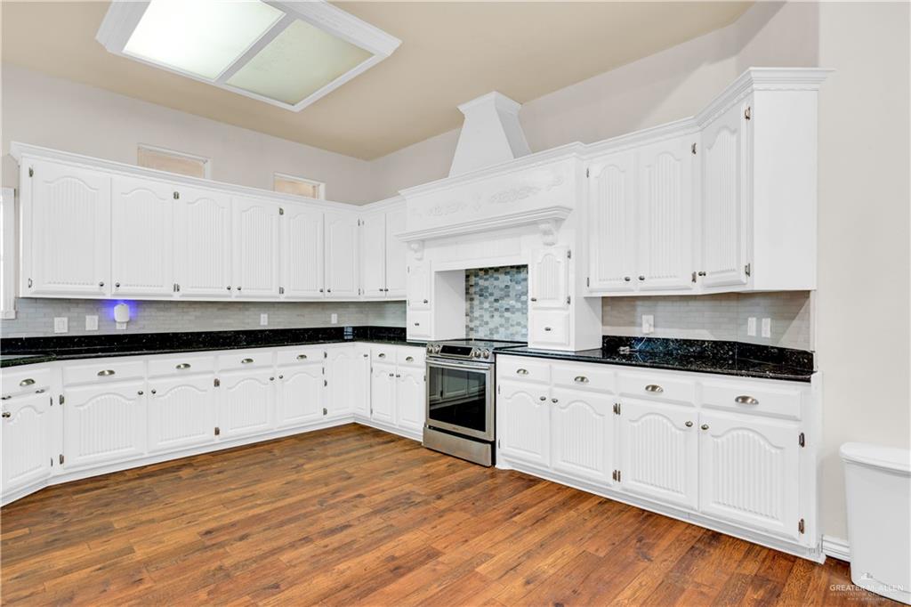 3517 Princess Street Edinburg, TX 78539 - Photo 9 of 22 a kitchen with granite countertop white cabinets and white appliances