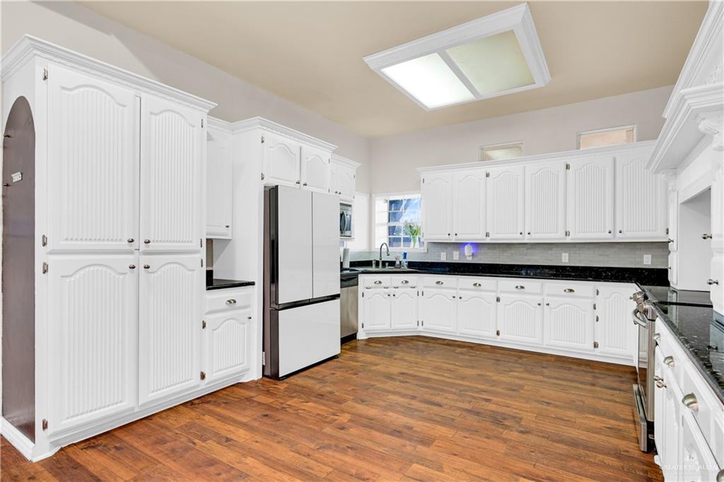 3517 Princess Street Edinburg, TX 78539 - Photo 10 of 22 a kitchen with stainless steel appliances a refrigerator sink and cabinets