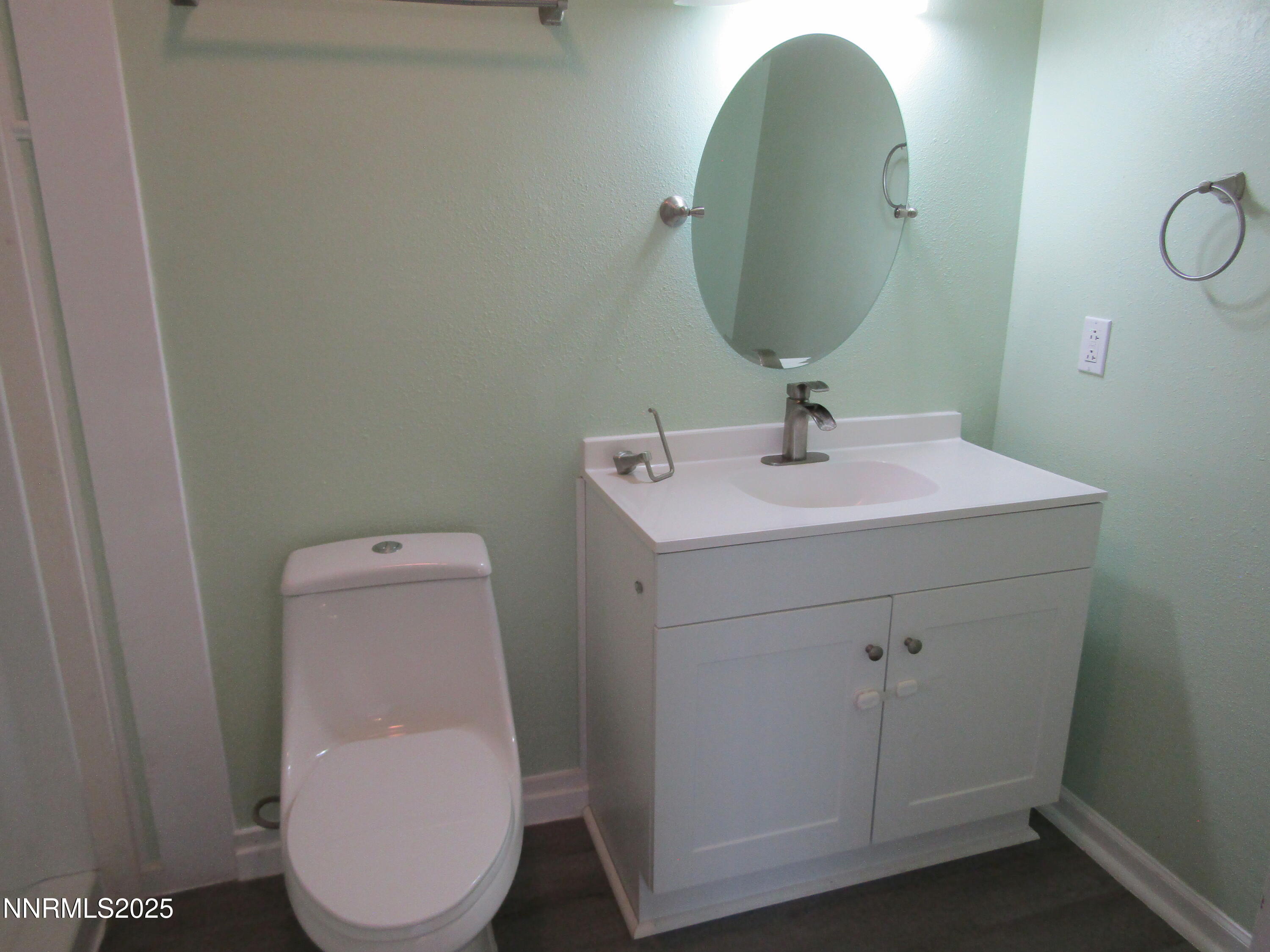 111 South Whitacre Street Yerington, NV 89447 - Photo 15 of 30 a bathroom with a toilet sink and mirror