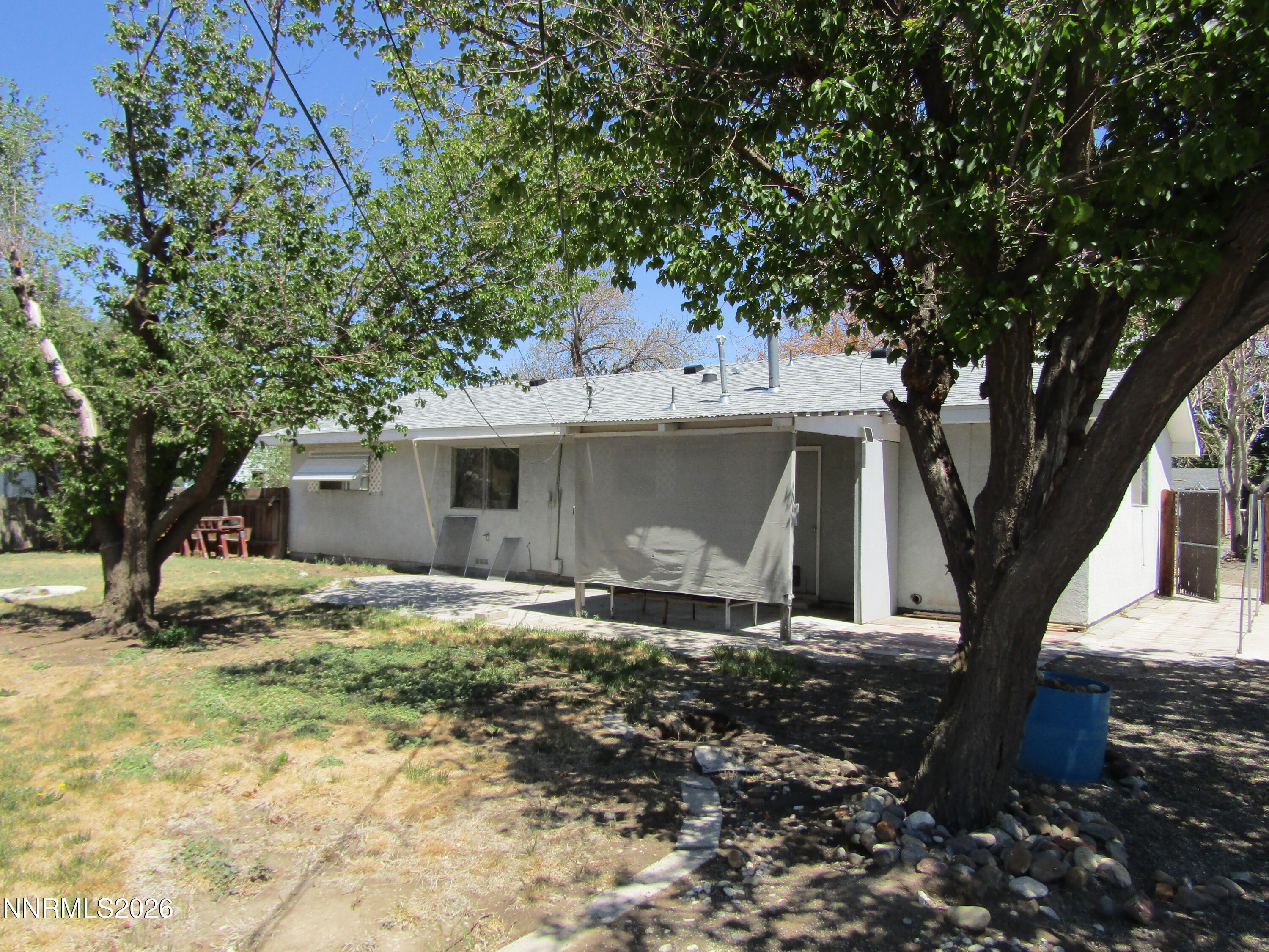 111 South Whitacre Street Yerington, NV 89447 - Photo 27 of 30 a house with trees in the background