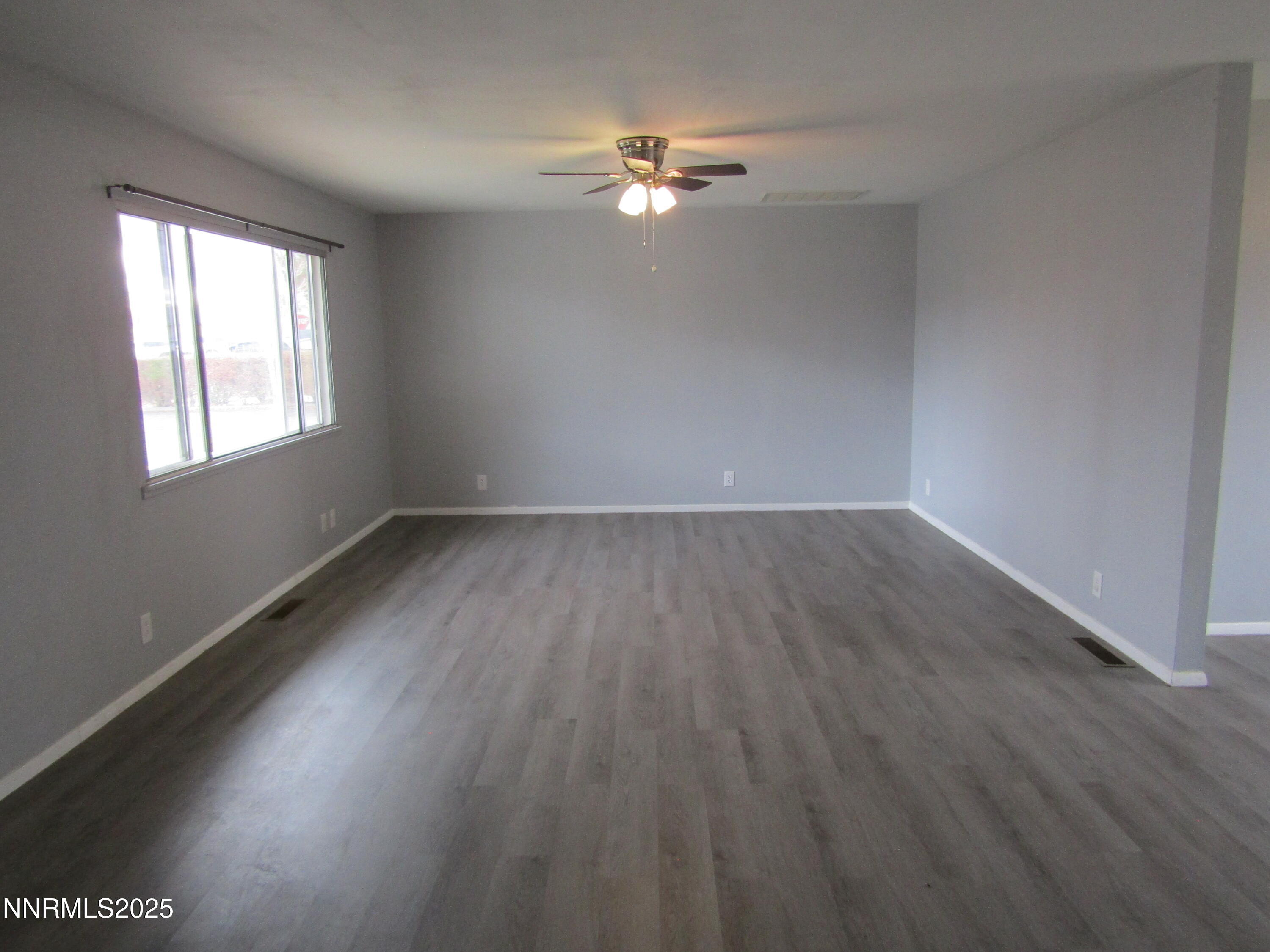 111 South Whitacre Street Yerington, NV 89447 - Photo 4 of 30 wooden floor in an empty room with a window