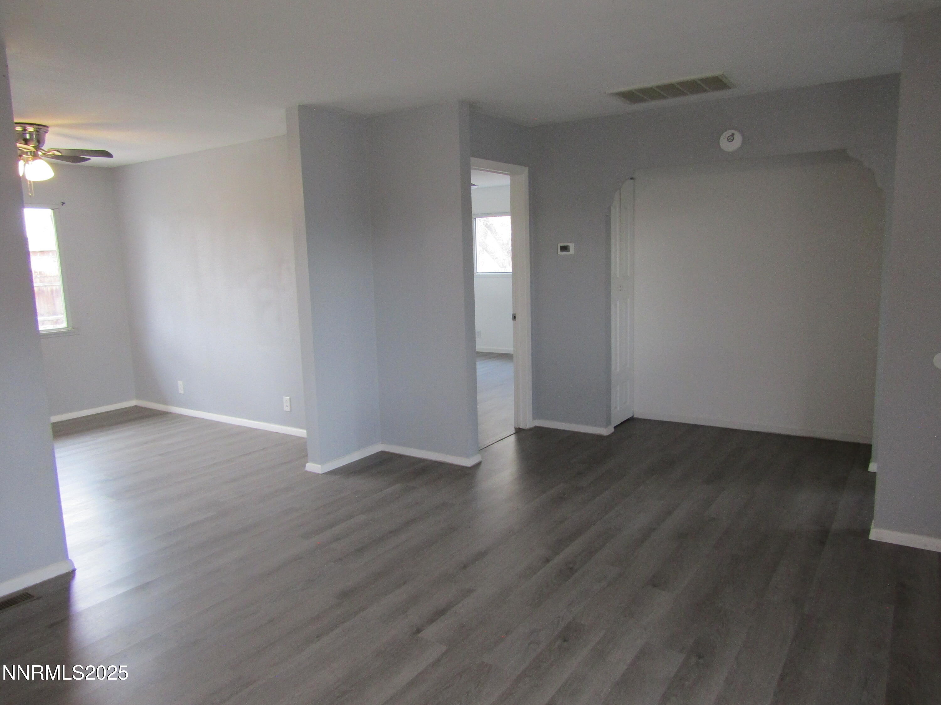111 South Whitacre Street Yerington, NV 89447 - Photo 8 of 30 a view of an empty room with wooden floor and a window