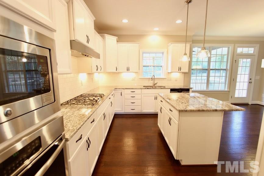7721 Wilderness Road Raleigh, NC 27613 - Photo 1 of 1 a kitchen with a sink stove and cabinets