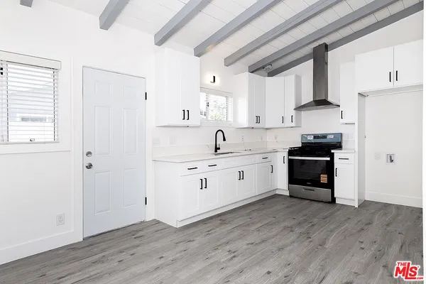 a kitchen with granite countertop white cabinets and white appliances