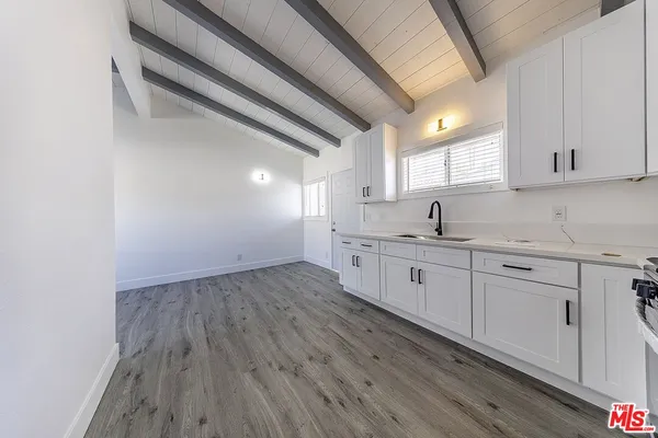 a kitchen with sink cabinets and wooden floor