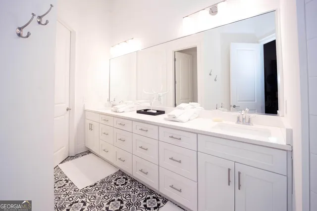 a bathroom with a double vanity sink and mirror