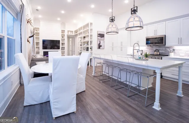 a large kitchen with kitchen island a wooden floor and appliances