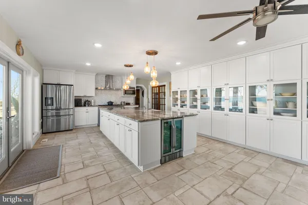 a kitchen with stainless steel appliances granite countertop a refrigerator a stove a sink a microwave and cabinets