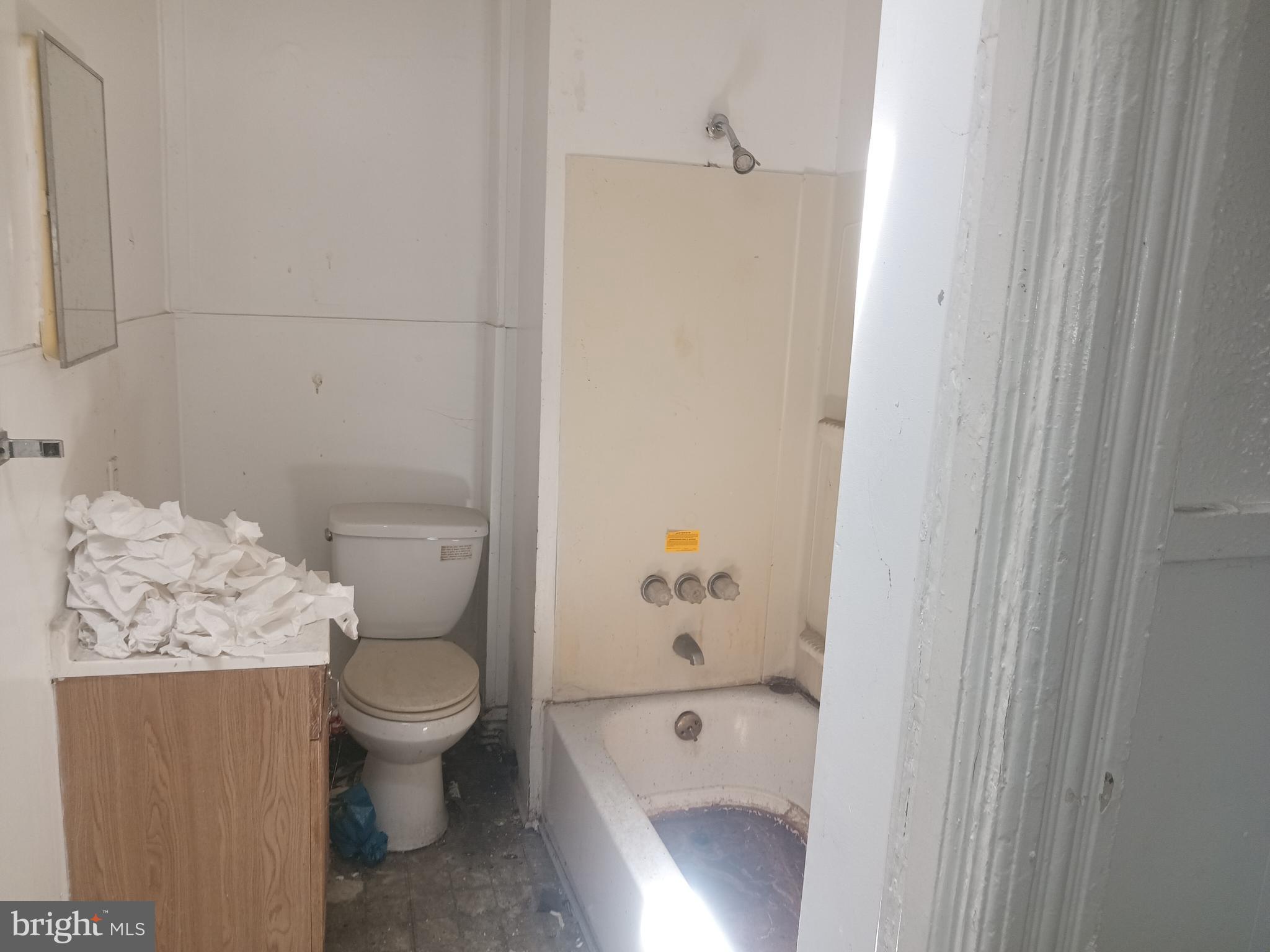 2414 East Oliver Street Baltimore, MD 21213 - Photo 7 of 9 a bathroom with a toilet and shower