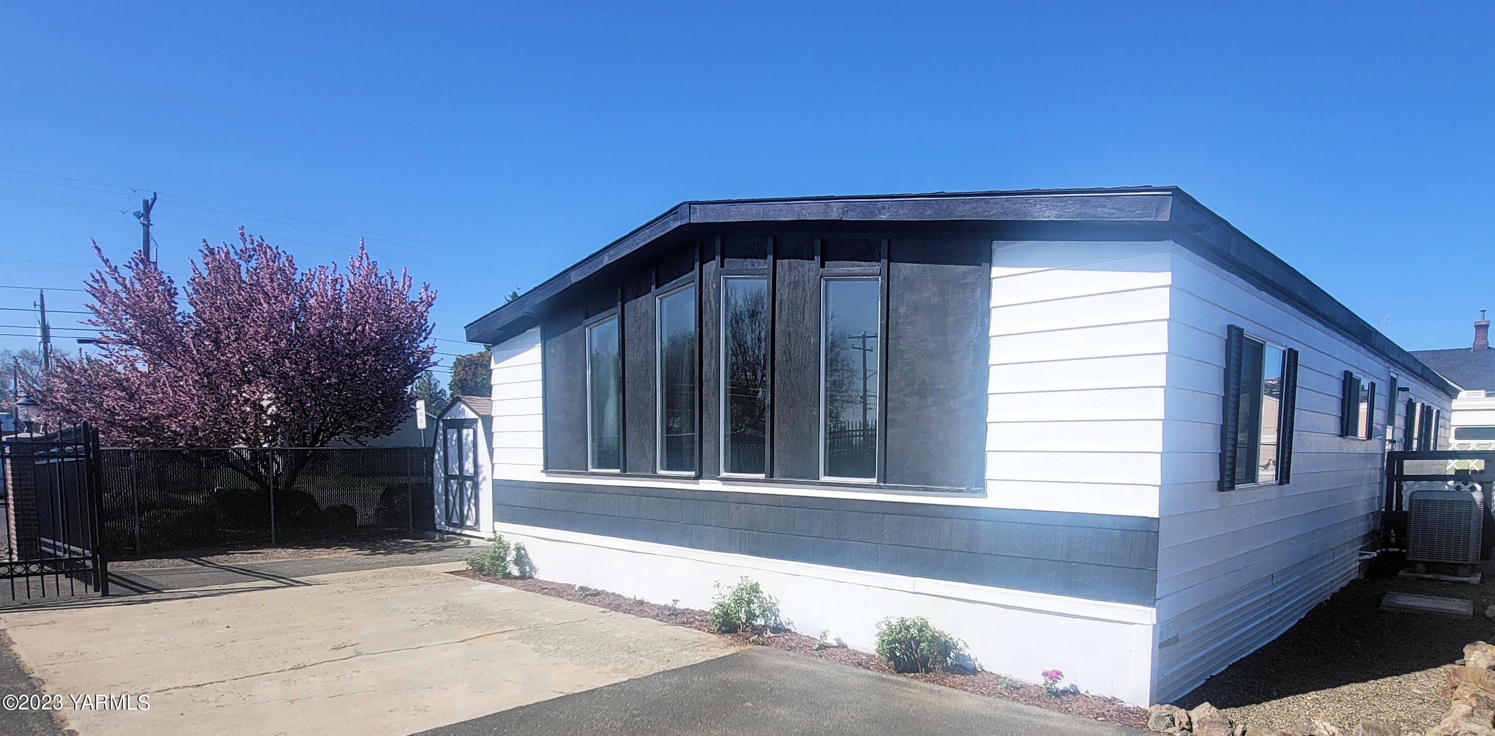 3005 Castlevale Road, Unit 50 Yakima, WA 98902 - Photo 2 of 16 a front view of a house with a garden