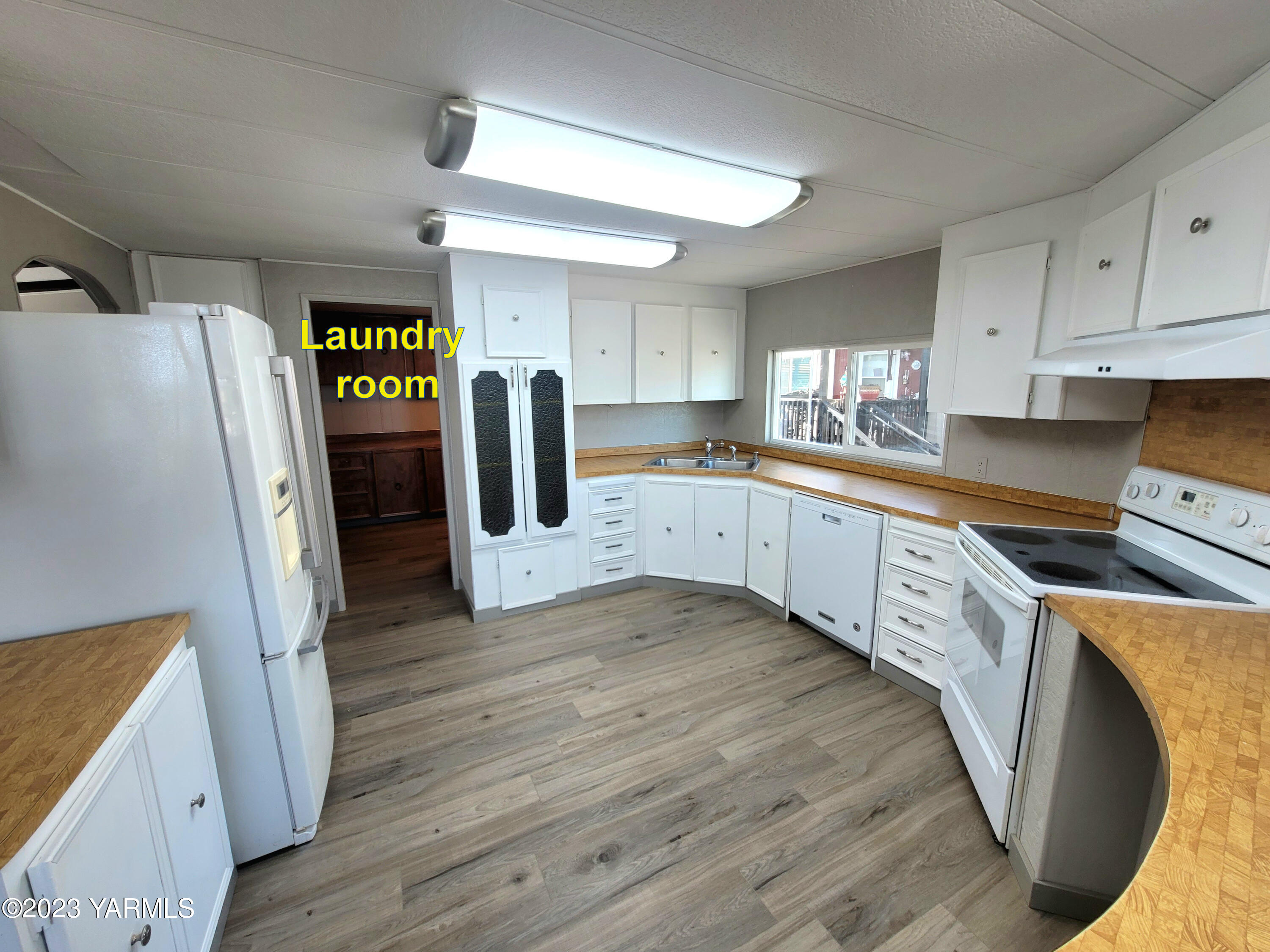 3005 Castlevale Road, Unit 50 Yakima, WA 98902 - Photo 6 of 16 a kitchen with cabinets and wooden floor