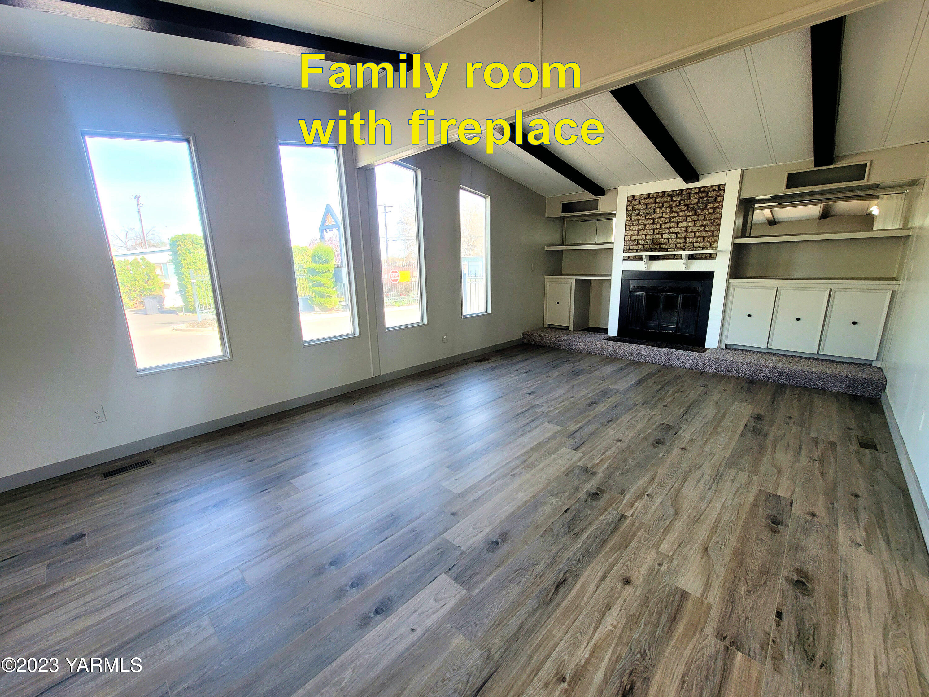 3005 Castlevale Road, Unit 50 Yakima, WA 98902 - Photo 7 of 16 wooden floor in an empty room with a fireplace