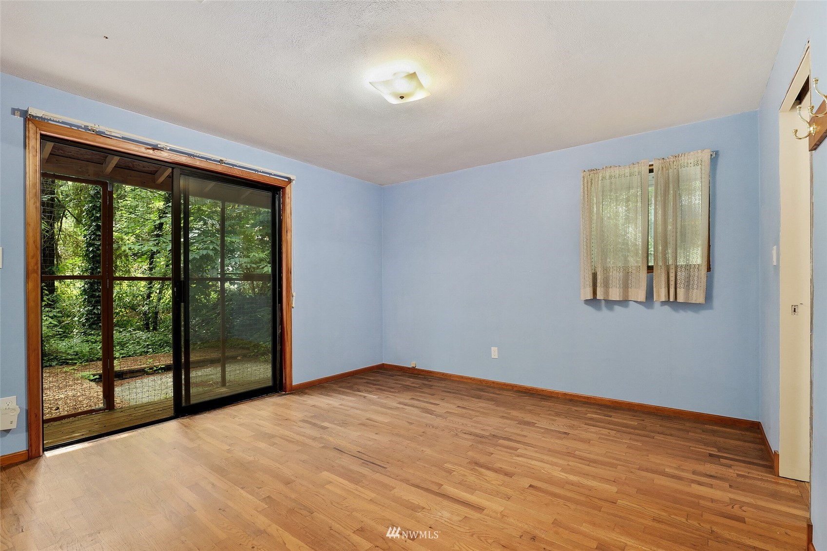 22914 2nd Avenue Southeast Bothell, WA 98021 - Photo 12 of 20 a view of an empty room with wooden floor and a window