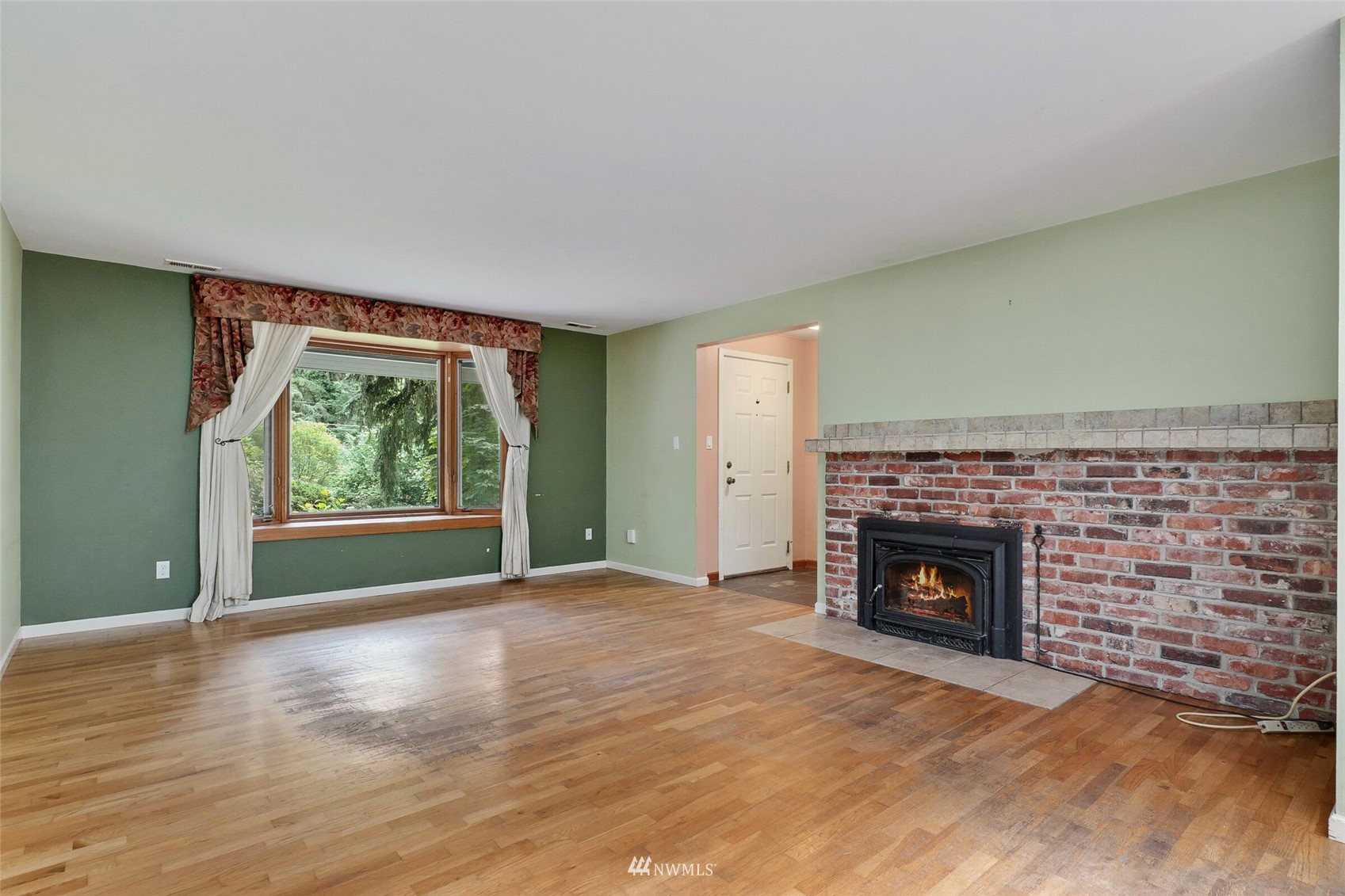 22914 2nd Avenue Southeast Bothell, WA 98021 - Photo 5 of 20 a view of an empty room with a fireplace and a window