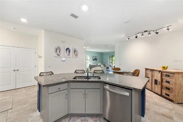 a kitchen with stainless steel appliances granite countertop a sink and cabinets