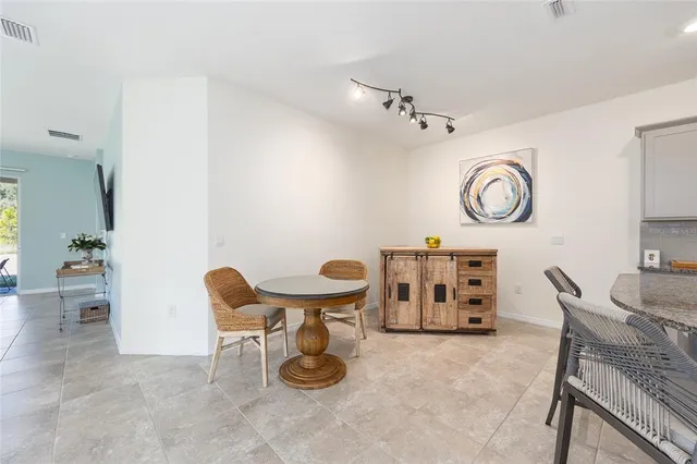 a dining room with furniture and a clock