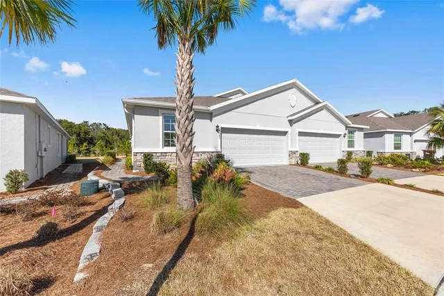 a view of a house with backyard and swimming pool