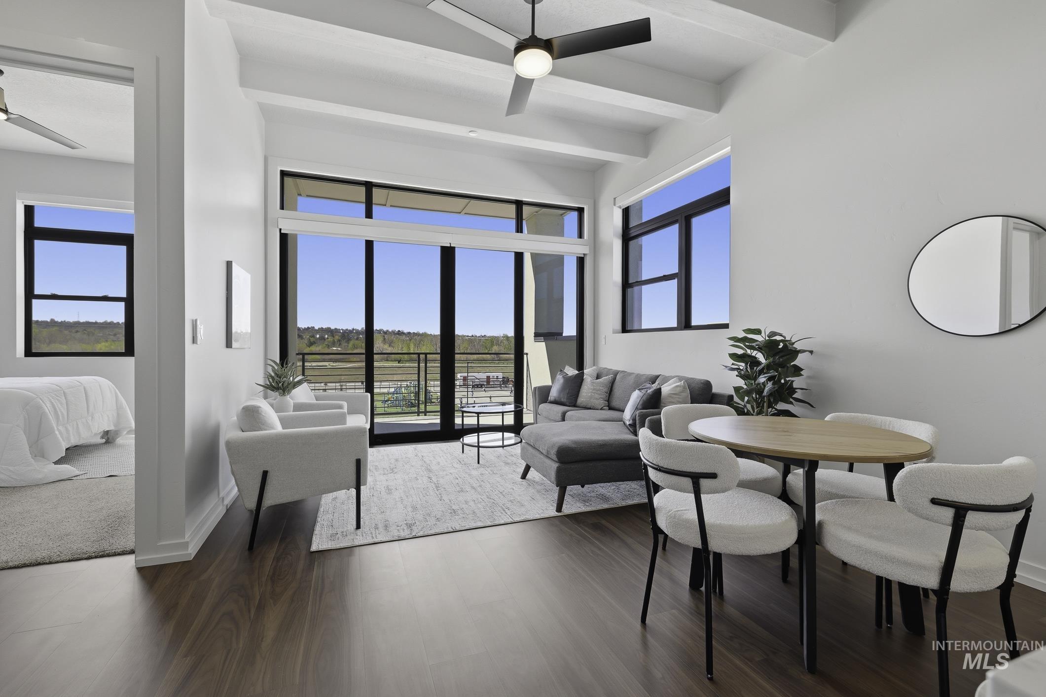 4250 East Haystack Street, Unit 308 Boise, ID 83716 - Photo 1 of 27 Living area with a ceiling fan, beamed ceiling, and dark wood finished floors