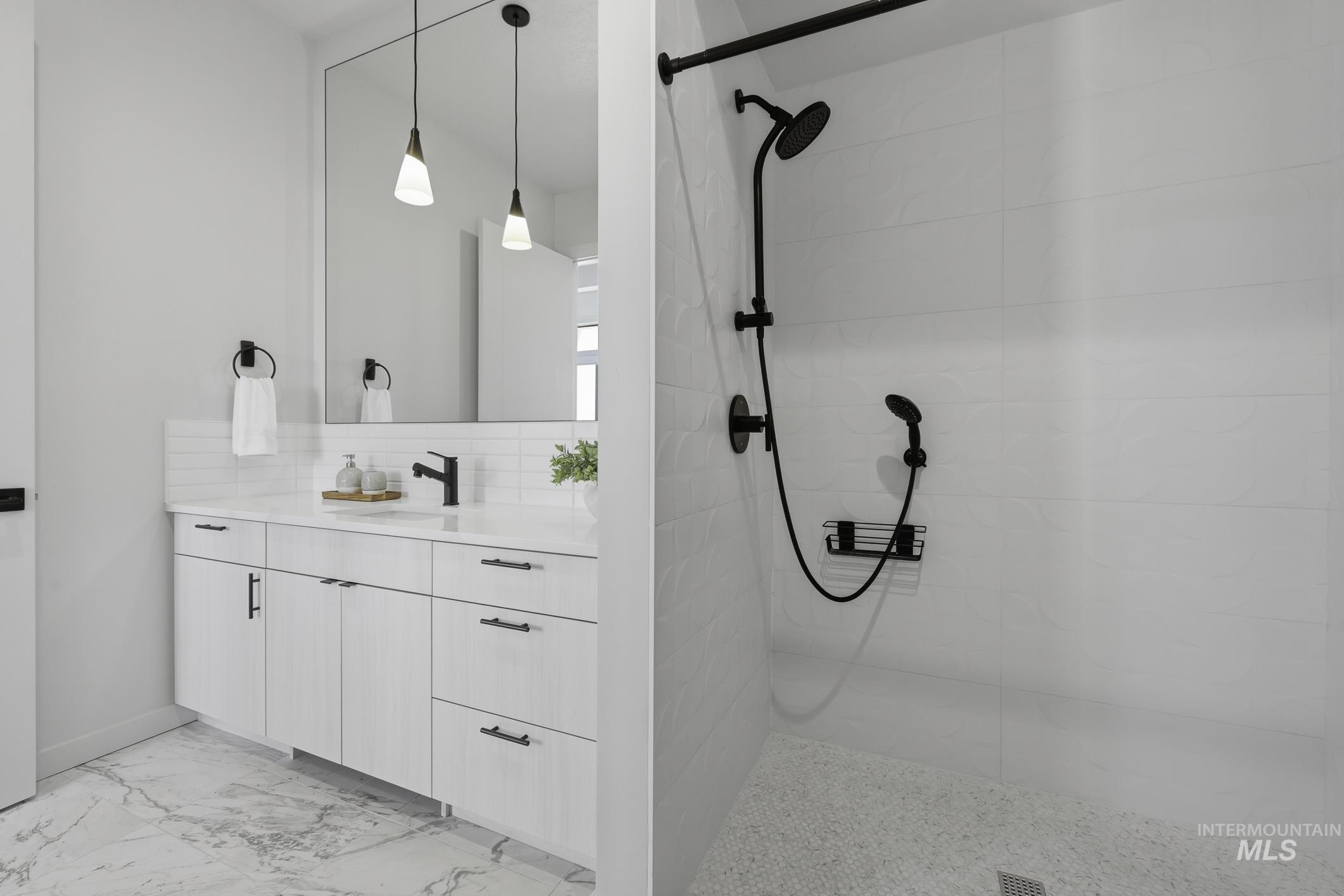 4250 East Haystack Street, Unit 308 Boise, ID 83716 - Photo 16 of 27 Full bathroom with vanity, a walk in shower, light marble finish floors, and decorative backsplash