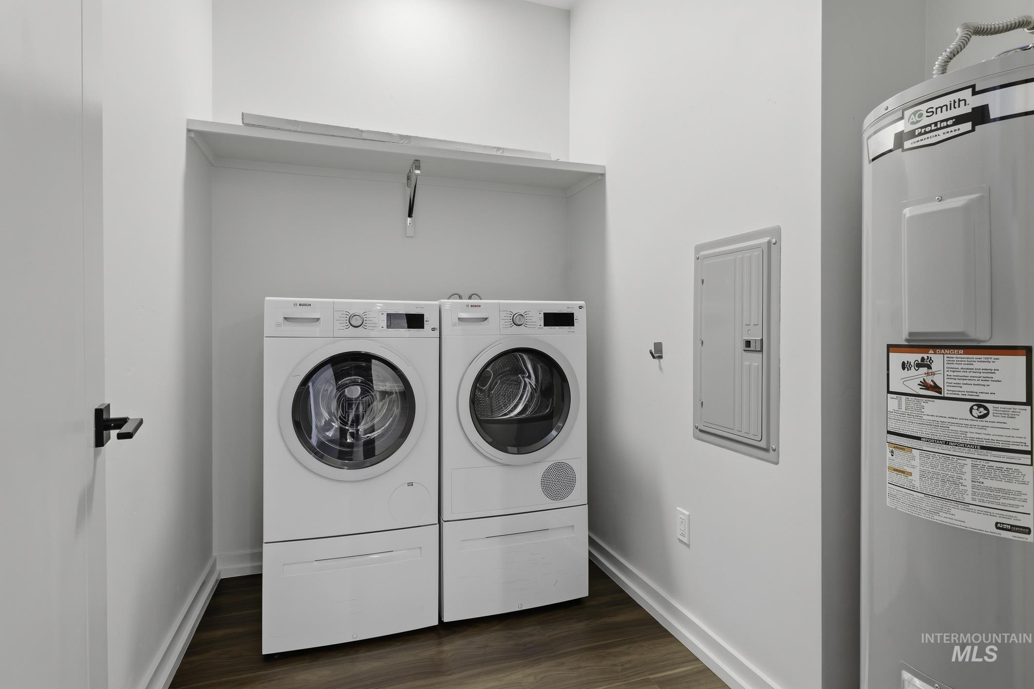 4250 East Haystack Street, Unit 308 Boise, ID 83716 - Photo 19 of 27 Laundry area featuring water heater, electric panel, dark wood-type flooring, and washer and clothes dryer