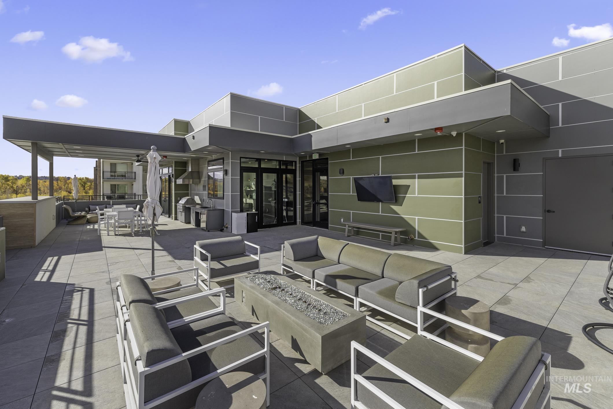 4250 East Haystack Street, Unit 308 Boise, ID 83716 - Photo 24 of 27 View of patio / terrace with an outdoor living space with a fire pit