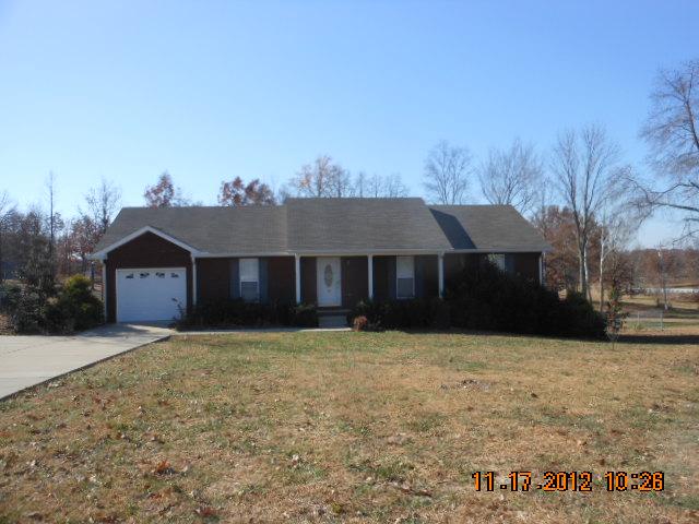 108 Switchboard Road Portland, TN 37148 - Photo 1 of 18 a house that has a tree in front of it