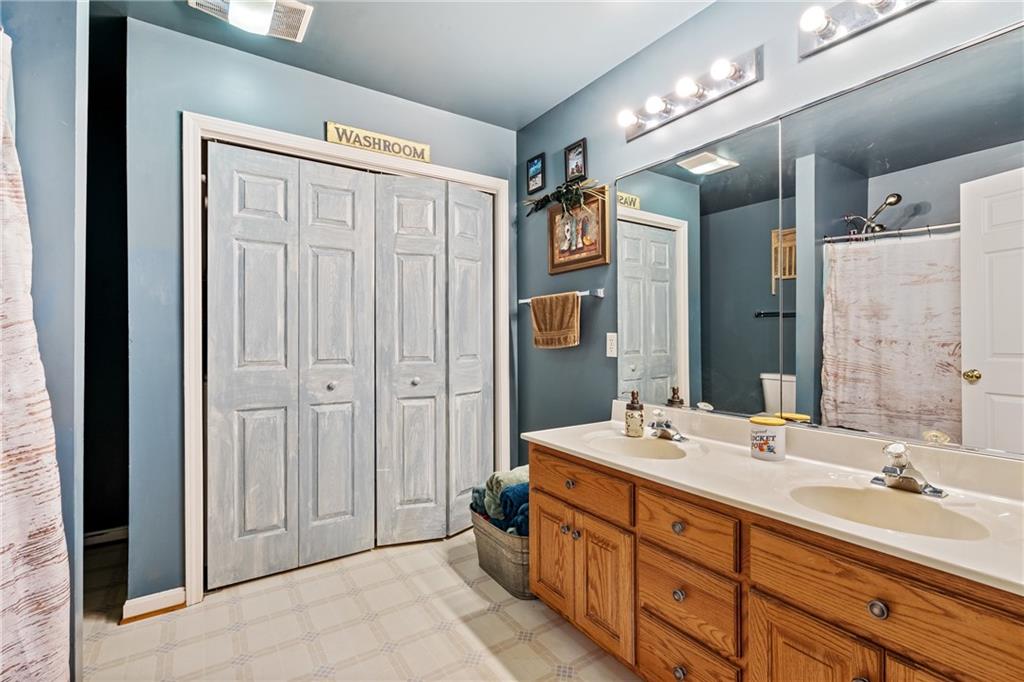 328 Lyons Road Stoneboro, PA 16153 - Photo 12 of 25 a bathroom with double vanity sinks and a mirror
