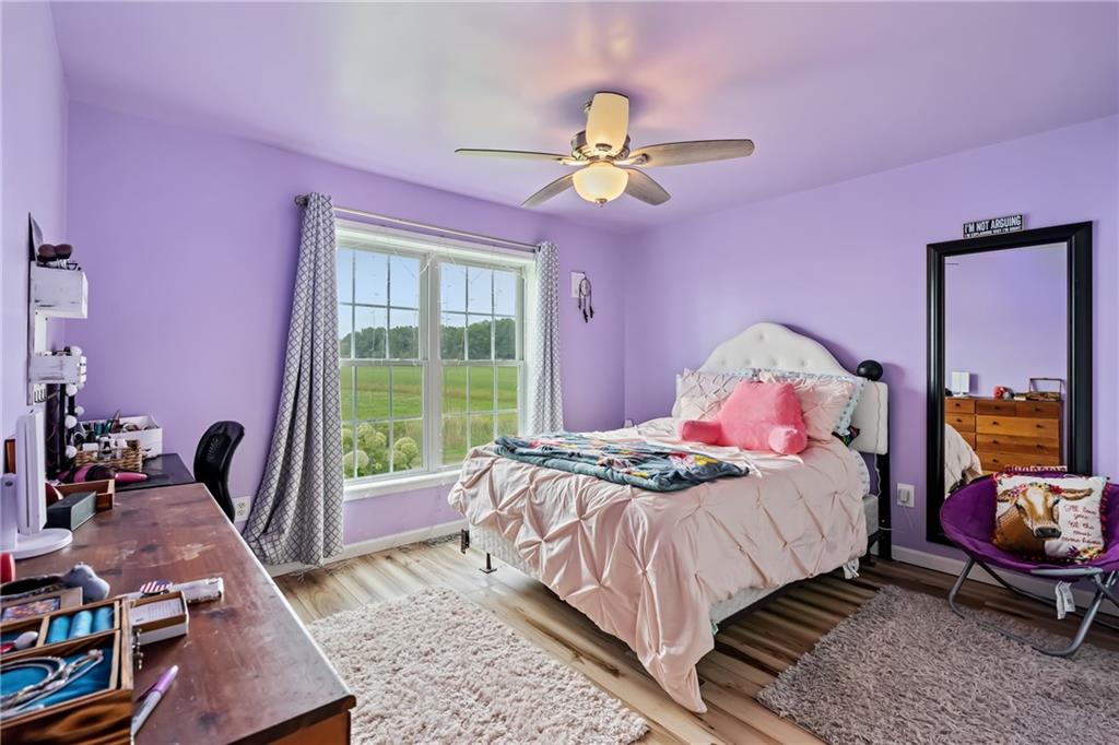 328 Lyons Road Stoneboro, PA 16153 - Photo 14 of 25 a bedroom with a bed and wooden floor