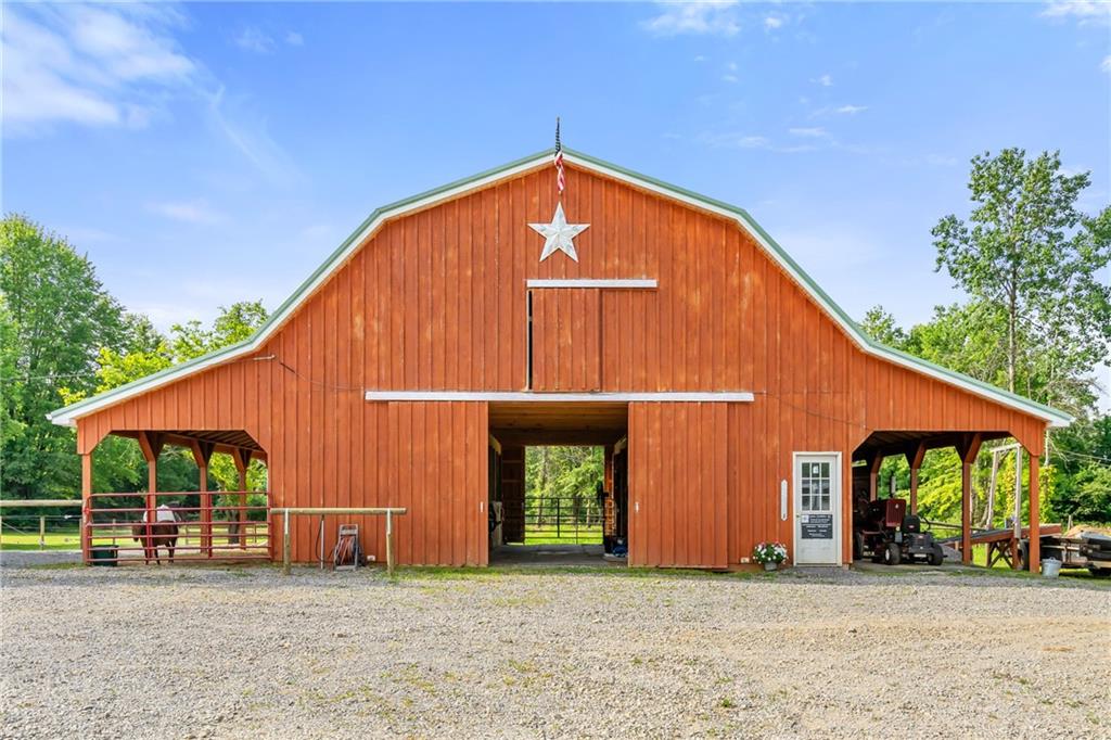 328 Lyons Road Stoneboro, PA 16153 - Photo 19 of 25 a view of a house with large windows and a yard