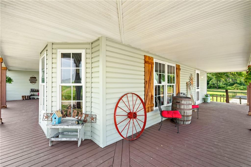 328 Lyons Road Stoneboro, PA 16153 - Photo 4 of 25 a view of a house with wooden deck and furniture