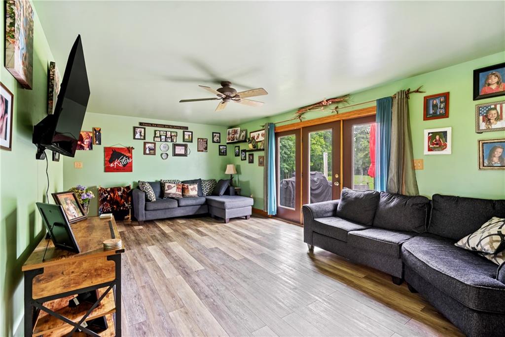 328 Lyons Road Stoneboro, PA 16153 - Photo 9 of 25 a living room with furniture ceiling fan and a flat screen tv