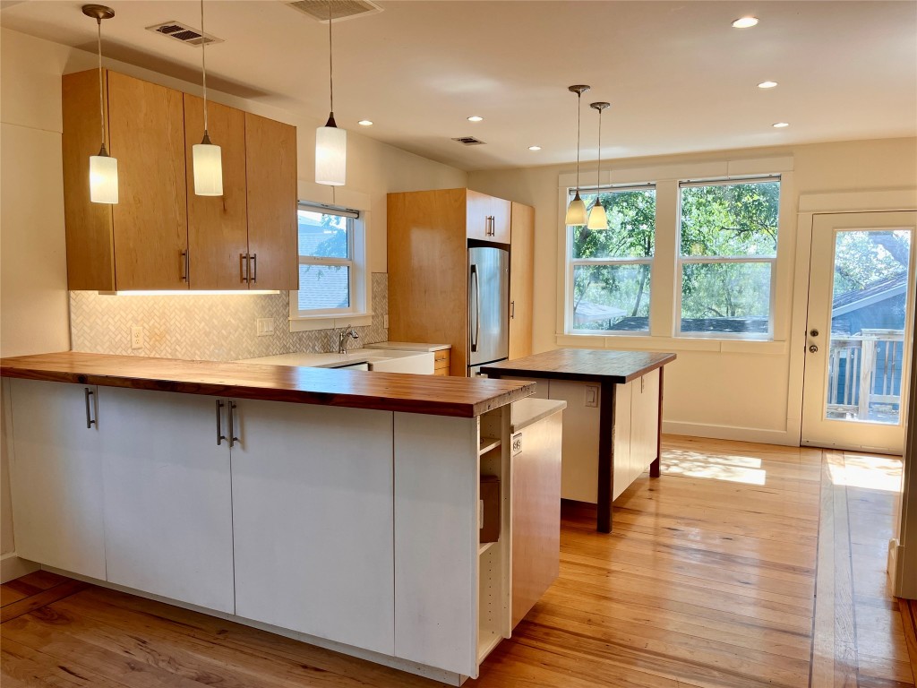 Enjoy quartz countertops, handcrafted cabinetry, a spacious island and bar made from reclaimed wood salvaged from the original 1930s home.