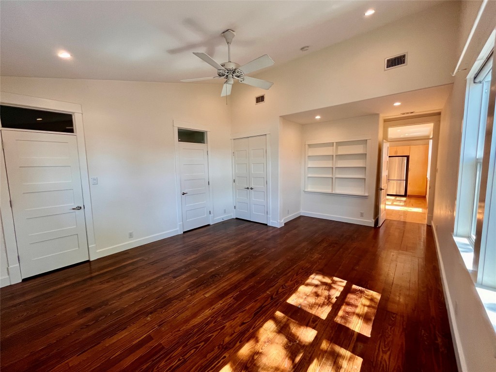 2209 East 18th Street, Unit A Austin, TX 78702 - Photo 26 of 35 Unfurnished bedroom featuring original restored pine flooring, ceiling fan, and built in storage.