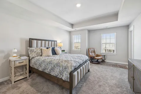 a spacious bedroom with a bed and a window