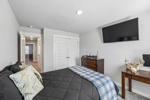 a bedroom with a bed and a flat screen tv