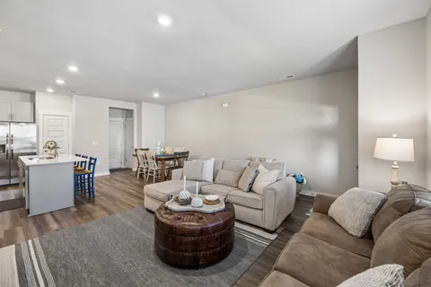 a living room with furniture and a wooden floor
