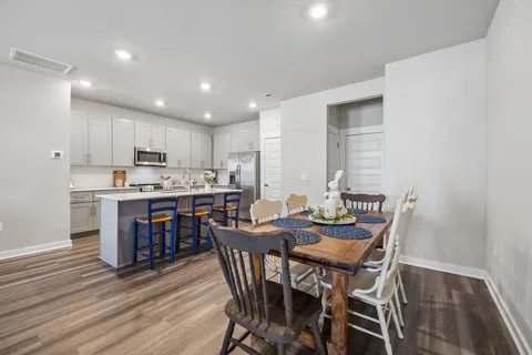 a view of a dining room with furniture and wooden floor