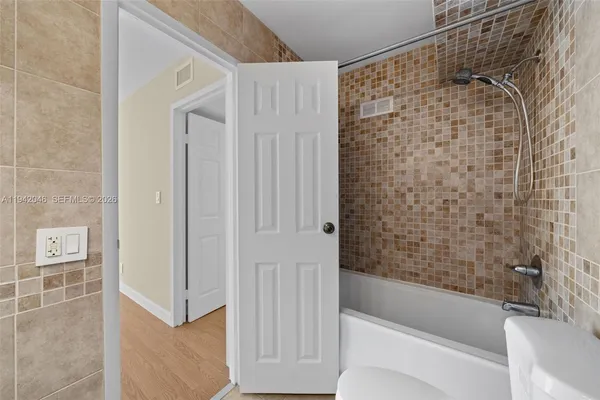 a bathroom with a bathtub and a shower