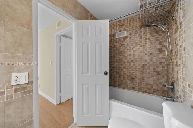 a bathroom with a bathtub and a shower