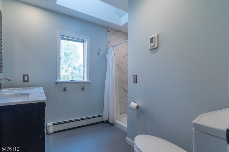9 Wayside Lane Lebanon, NJ 08833 - Photo 18 of 40 a bathroom with a sink toilet and window