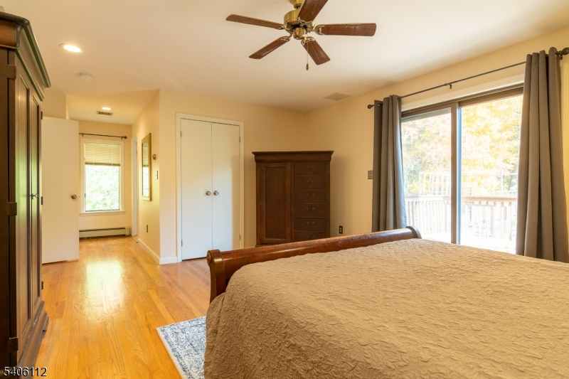 9 Wayside Lane Lebanon, NJ 08833 - Photo 20 of 40 a bedroom with a bed and a chandelier