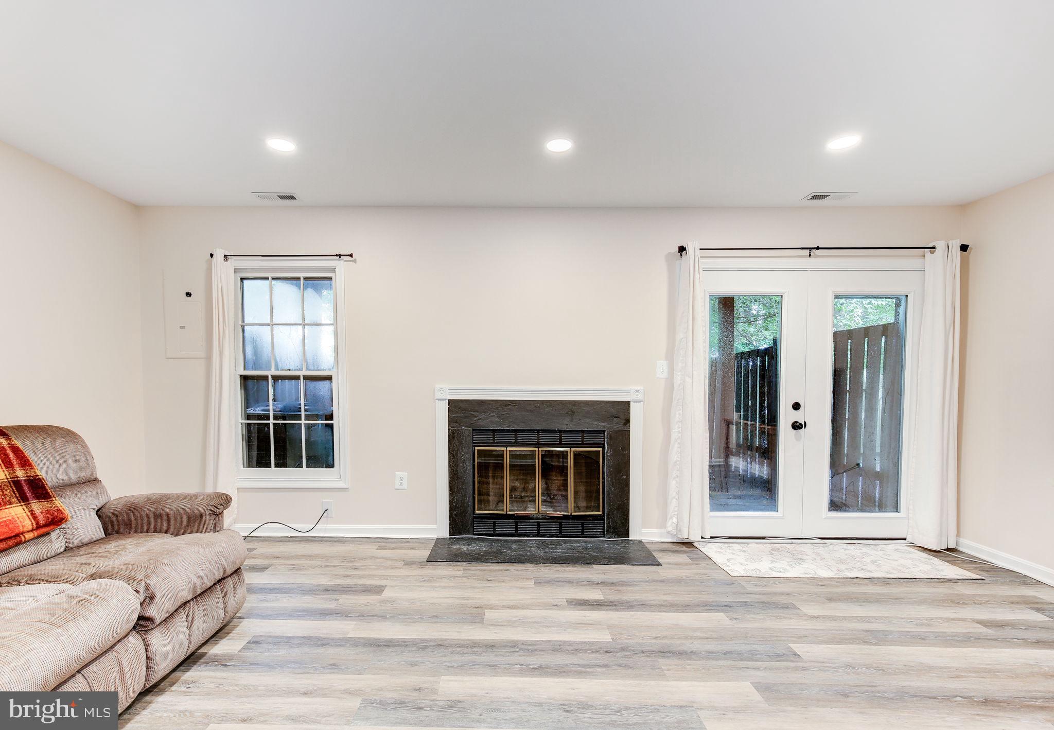 14523 Cambridge Circle Laurel, MD 20707 - Photo 31 of 39 Basement with fireplace and walkout french doors
