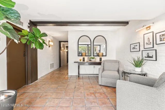 a living room with furniture flowerpot and flower pot