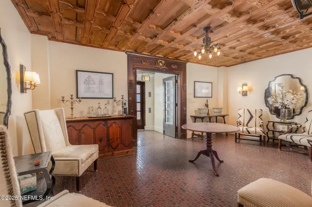 a living room with furniture a clock and a table