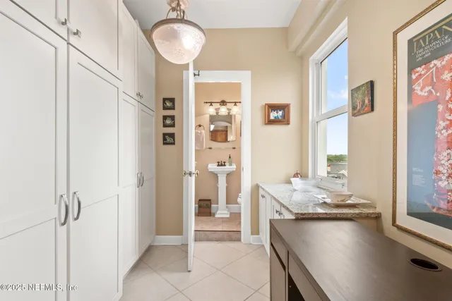 a spacious bathroom with a granite countertop sink and a mirror