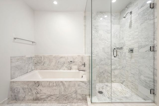 a bathroom with a bathtub and a shower