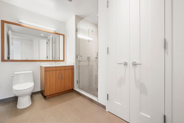 a bathroom with a toilet sink and a mirror