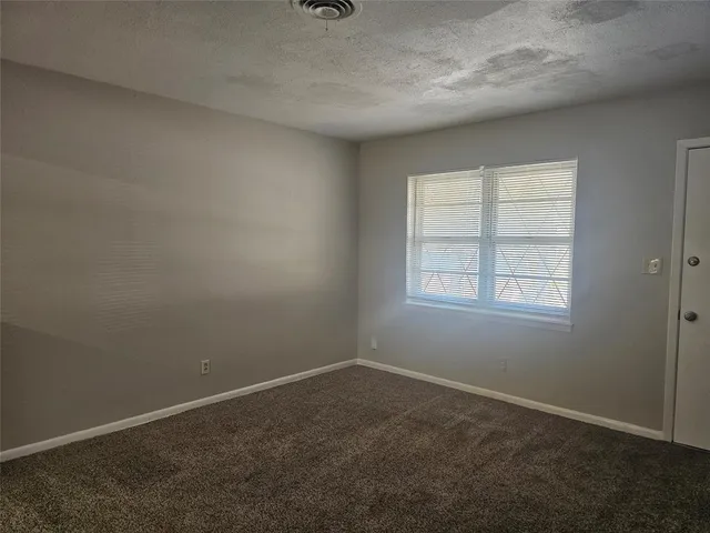 an empty room with a empty space and window